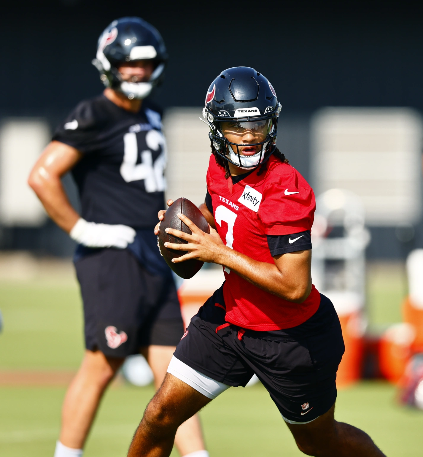 NFL player holding football during Texans training camp practice session