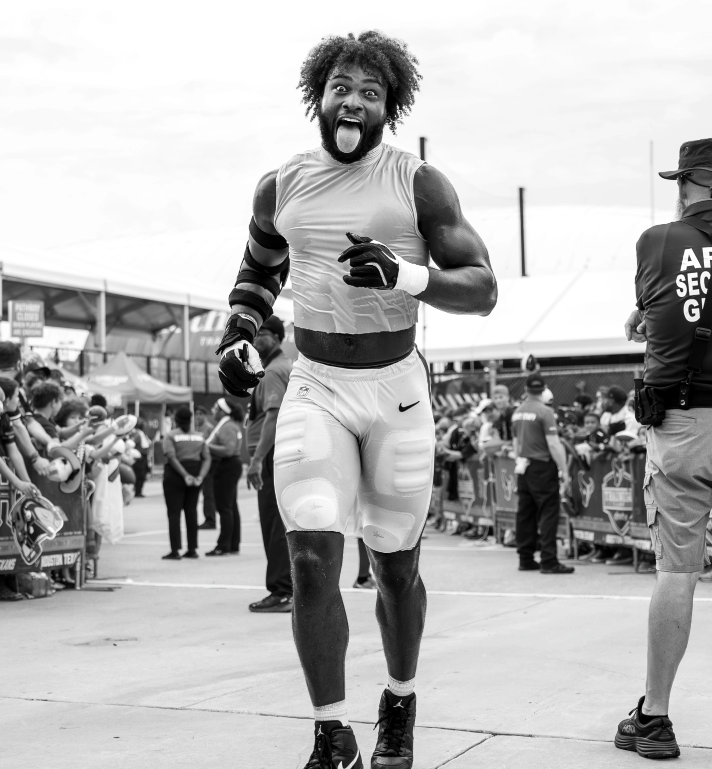 Houston Texans player interacting with supporters at preseason practice event