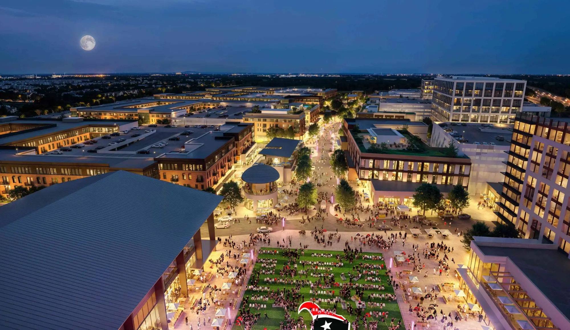 Aerial view of vibrant mixed use district illuminated at night